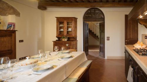 a kitchen with a large white table with glasses on it at Agriturismo Cerreto in Pienza