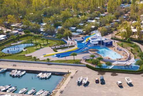 an aerial view of a water park with boats in it at Oh! Campings - L'Espiguette in Le Grau-du-Roi