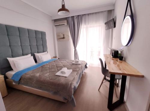 A bed or beds in a room at Moudania Mare Hotel