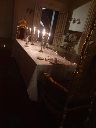 a table with candles on it in a dark room at Salon Boyer in Épernay