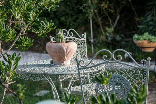 a table with a vase sitting on top at Studios Tasos in Chrysi Ammoudia