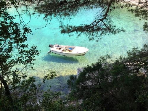 a boat in a body of water at HVAR BEACH VILLA in Jelsa