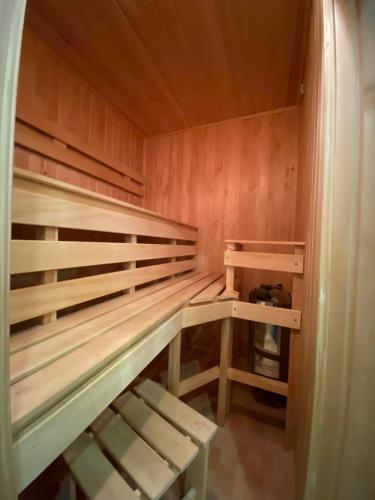 a wooden sauna with wooden shelves in a room at Spadok in Kamianets-Podilskyi