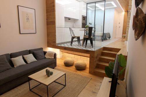 a living room with a couch and a table at El Secreto de Portales in Logroño