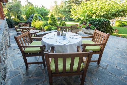 a table with a white table cloth on a patio at Hotel Grèvol Spa in Camprodon