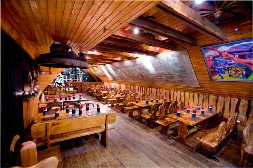 a restaurant with wooden tables and chairs in a room at Hotel Viking in Hafnarfjördur