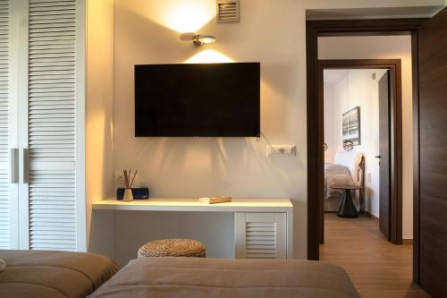 a living room with a tv on a wall at Villa Alkyoni Lindos in Líndos