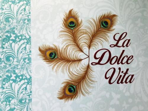 a peacock feather with the words la dolce vita at La Dolce Vita in Sigiriya