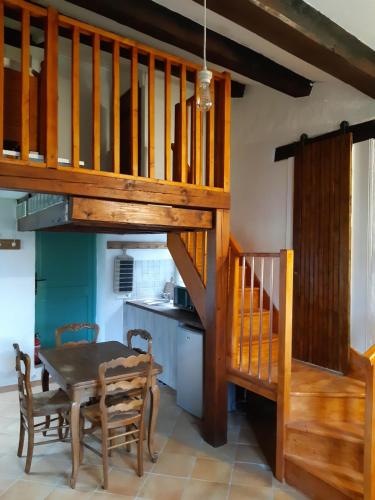 a kitchen with a table and a wooden staircase at Garden Annexe in Villeneuve-Loubet