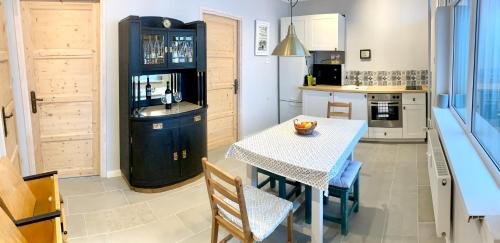 a kitchen with a table and chairs in a room at K1 Panoramic apartment in Szekszárd