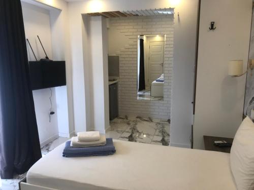 a white room with a bathroom with a mirror at CASA NEPTUN in OLD BATUMI in Batumi
