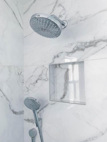 a shower with a mirror and a shower head at BelleVue Oasis - Adults Only in Palm Springs