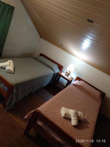 a room with two beds in a attic at Bon Bini in Punta Del Diablo