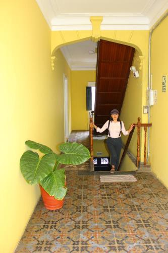 a woman standing on the stairs of a hallway at Holidays Hostel Arequipa in Arequipa