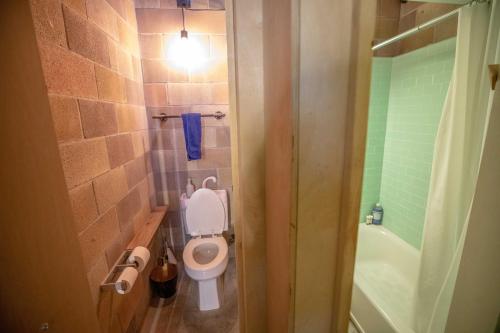 a small bathroom with a toilet and a shower at PodShare San Diego in San Diego