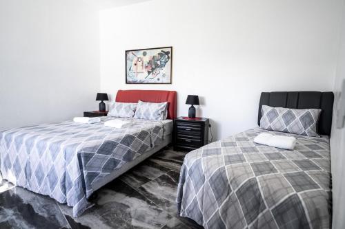 two beds sitting next to each other in a bedroom at Pacific View Dalaguete in Dalaguete