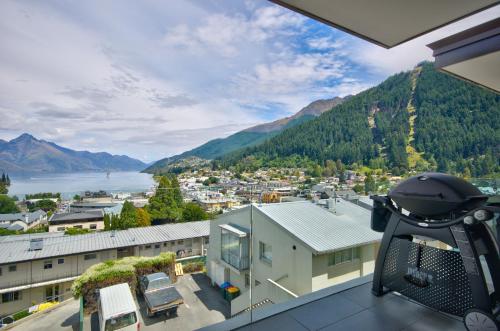 a view from the balcony of a house with a view of a city at Luxury on the Lake in Queenstown