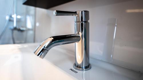 a bathroom sink with a chrome faucet on a counter at Pacific View Dalaguete in Dalaguete