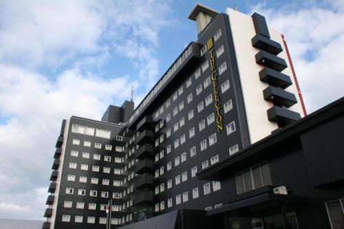 a black and white building with a traffic light at The Celecton Takamatsu in Takamatsu