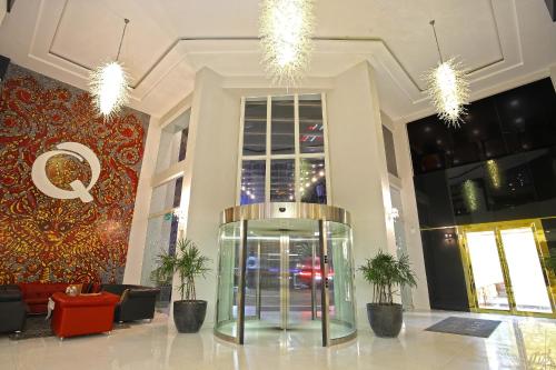 a lobby with a glass elevator in a building at Queenco Hotel & Casino in Sihanoukville