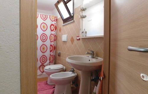 a bathroom with a sink and a toilet and a mirror at Villa Romeo - Alloggio Pastore - Private Pool in Santa Caterina dello Ionio