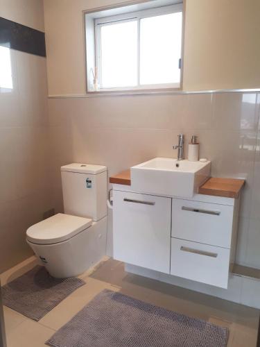 a bathroom with a toilet and a sink at Couples Retreat with Mountain View Near Hobart in Sandford