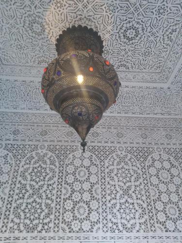 a chandelier hanging from a ceiling in a room at Riad Les Nuits de Marrakech in Marrakech