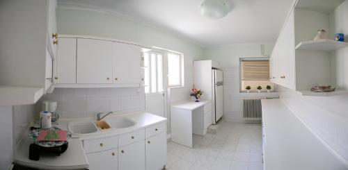 Dhílesi的住宿－Ioanna s house.Gorgeous house with sea view，白色的浴室设有两个盥洗盆和窗户。