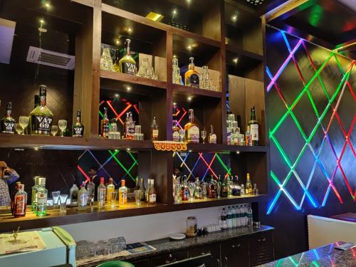 a bar with lots of bottles of alcohol at Hotel Suktara International in Siliguri