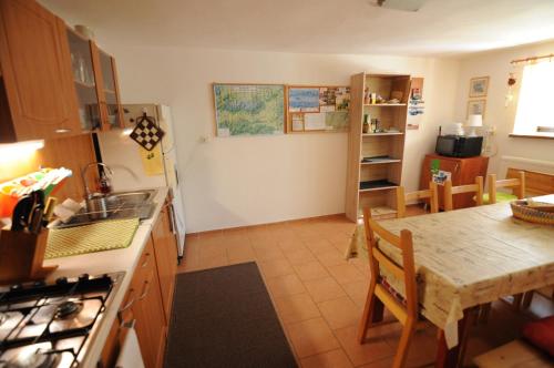 a kitchen with a table and a dining room at Privat Greenland in Liptovský Mikuláš