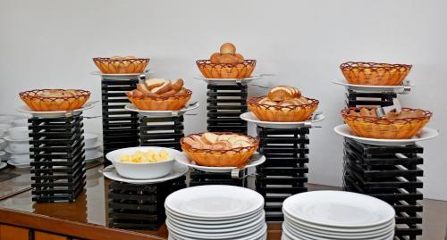 a display of baskets of bread on plates and bowls at Goldi Sands Hotel in Negombo