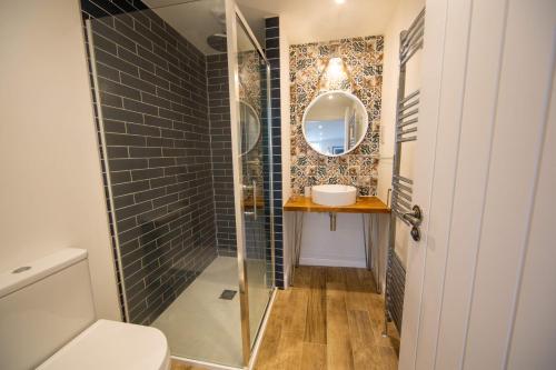 a bathroom with a toilet and a mirror at Gelly Cott in Padstow
