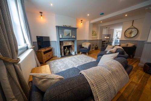 a living room with a couch and a fireplace at Gelly Cott in Padstow