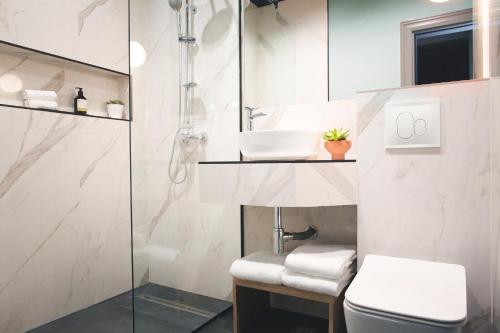 a bathroom with a sink and a toilet at JN Boutique Hotel in Bucharest
