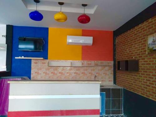 a brightly colored kitchen with colorful walls and lights at Bangkado Resort in Ratchaburi