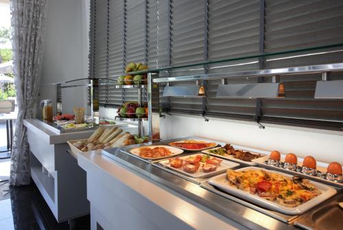 a buffet line with many different types of food at Lagouvardos Village Hotel in Marathopoli
