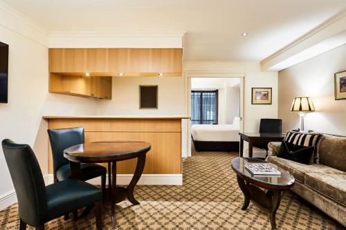 a living room with a couch and a table at Stamford Plaza Melbourne in Melbourne