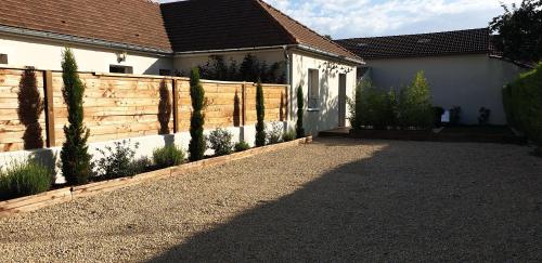 a fence in front of a house with a driveway at clos des mûriers in Beaune