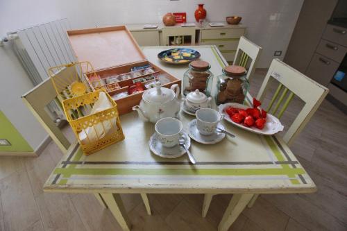 a table with a tea set on top of it at A Carubba du Bungiurnu in Borgio Verezzi