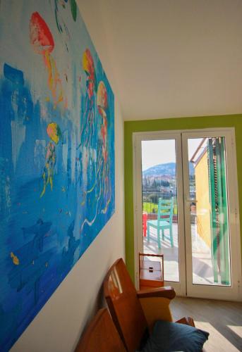 a room with a large painting on the wall at A Carubba du Bungiurnu in Borgio Verezzi
