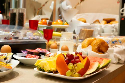 a buffet with plates of food on a table at Hotel Garni Regent in Euskirchen