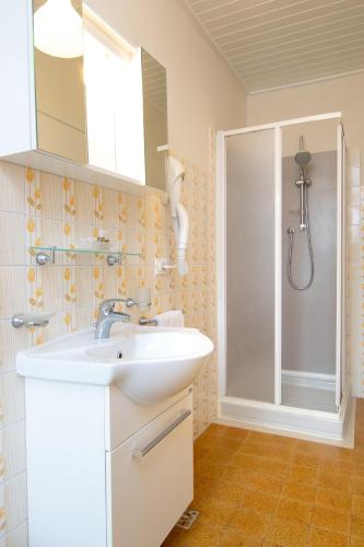 a bathroom with a sink and a shower at Acqua Verde Appartamenti in Peschiera del Garda