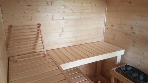 a wooden sauna with a bench in it at L'Attrape Reve in Saint-Vincent-de-Barrès