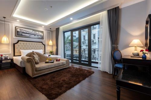 
a living room filled with furniture and a large window at Babylon Premium Hotel & Spa in Hanoi
