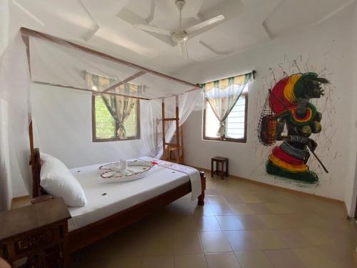 a room with a bed, a chair, and a painting on the wall at Wakanda Hotel in Nungwi