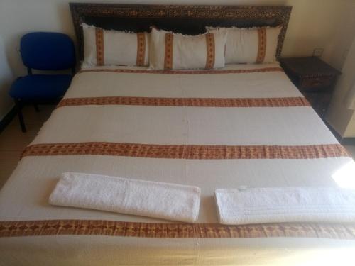 a bedroom with a bed with two towels on it at Honey Land Hotel Lalibela in Lalībela