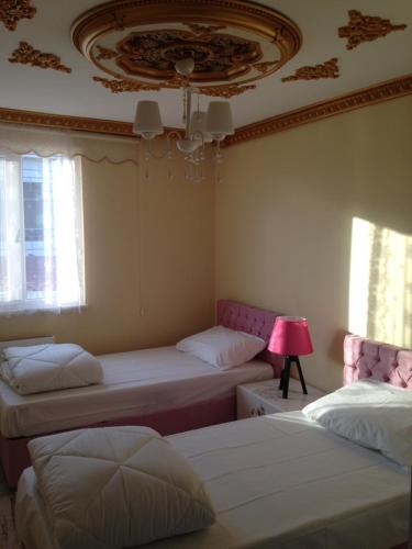 a bedroom with two beds and a ceiling at seasidehouse in Ordu