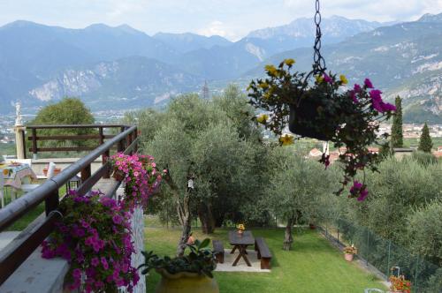 a garden with flowers hanging from a balcony at La Villa in Arco