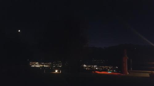 a view of a city at night with lights at La Villa in Arco