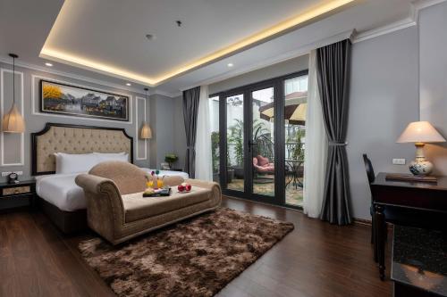 
a bedroom with a large bed and a large window at Babylon Premium Hotel & Spa in Hanoi
